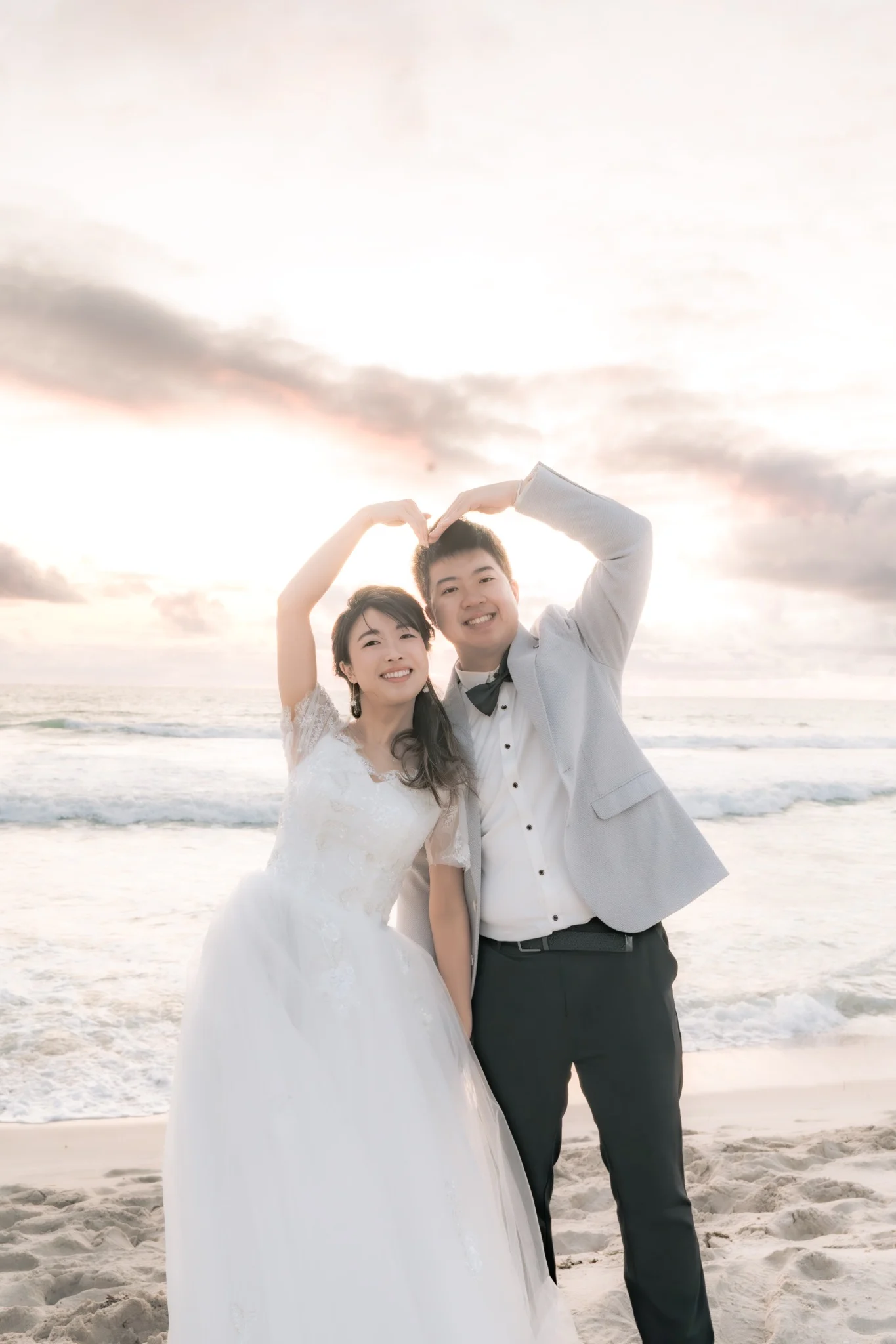 Angle and Andrew making a heart pose at Burns Beach in Perth, Western Australia