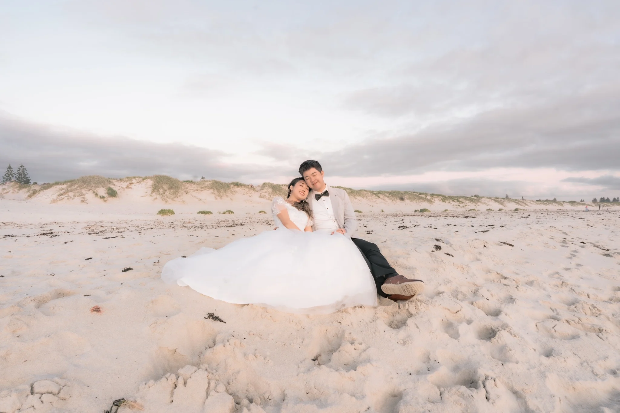 Angle and Andrew seated together at sunset at Burns Beach in Perth, Western Australia