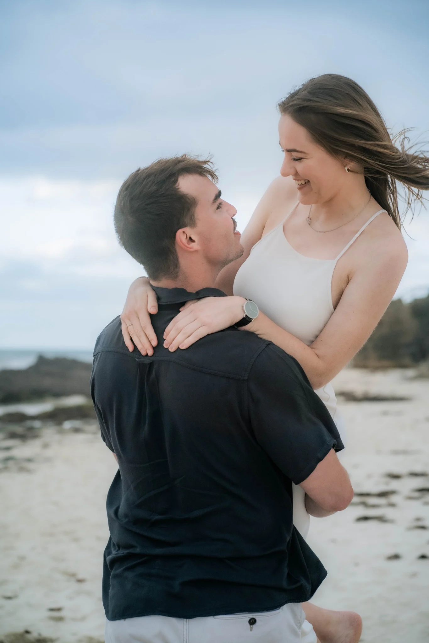 Henrico holding Marcja during their engagement photography session at Cottesloe Beach