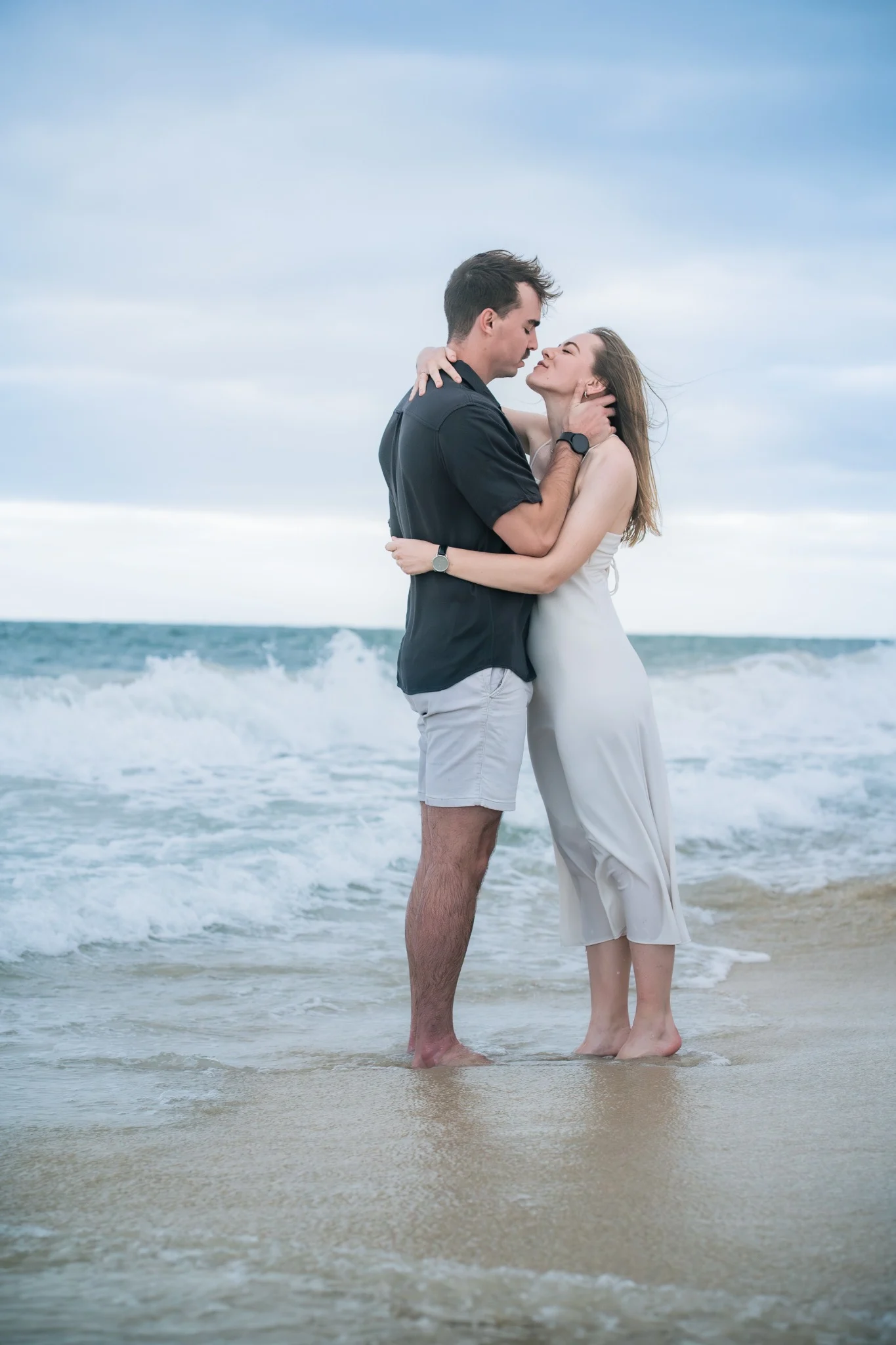 Marcja and Henrico embracing barefoot at the Cottesloe Beach shoreline
