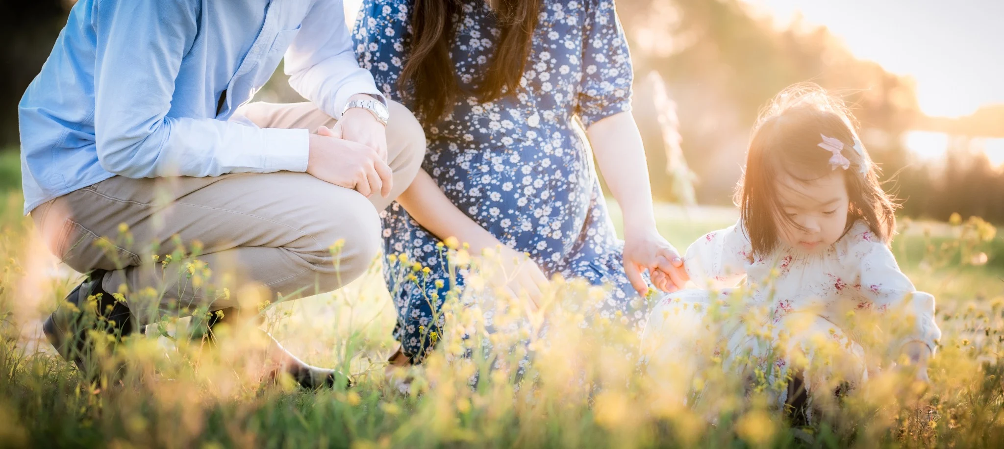 Family sharing a golden-hour moment together in a field during a Perth family photography session