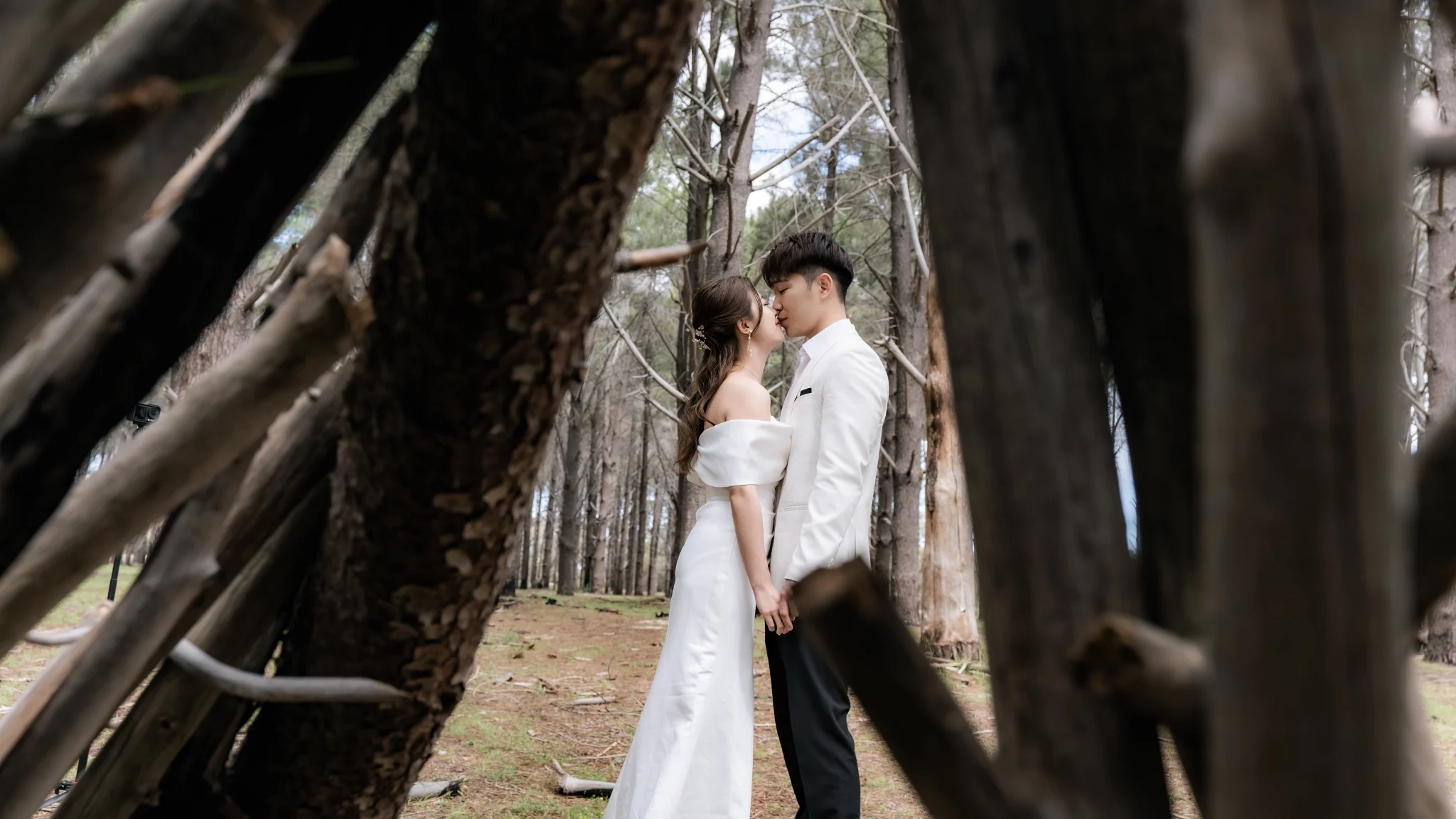 Sharon and Sam kissing among trees at Perry's Paddock in Perth, Western Australia