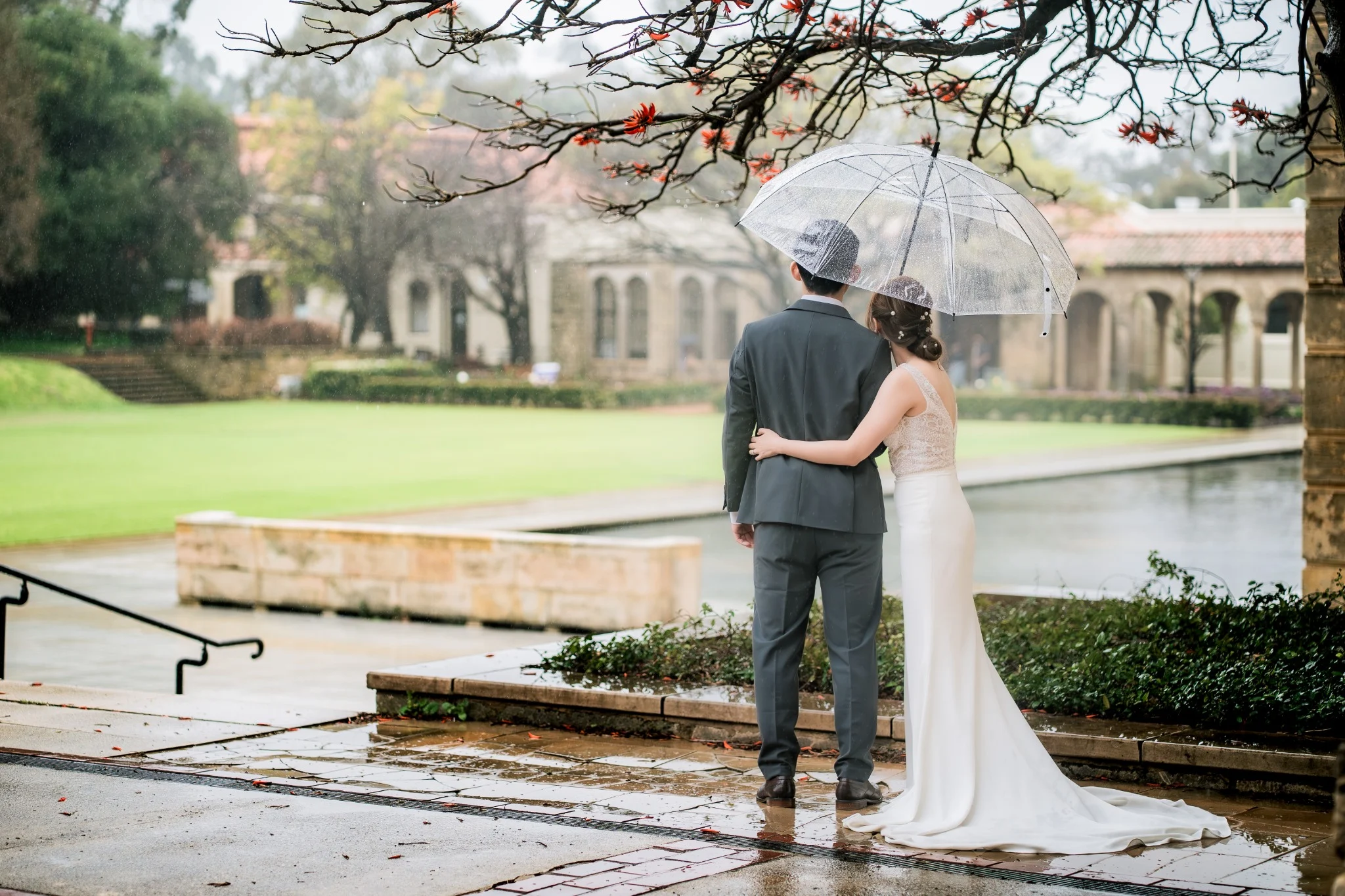 Couple standing beneath a clear umbrella at The University of Western Australia in Perth